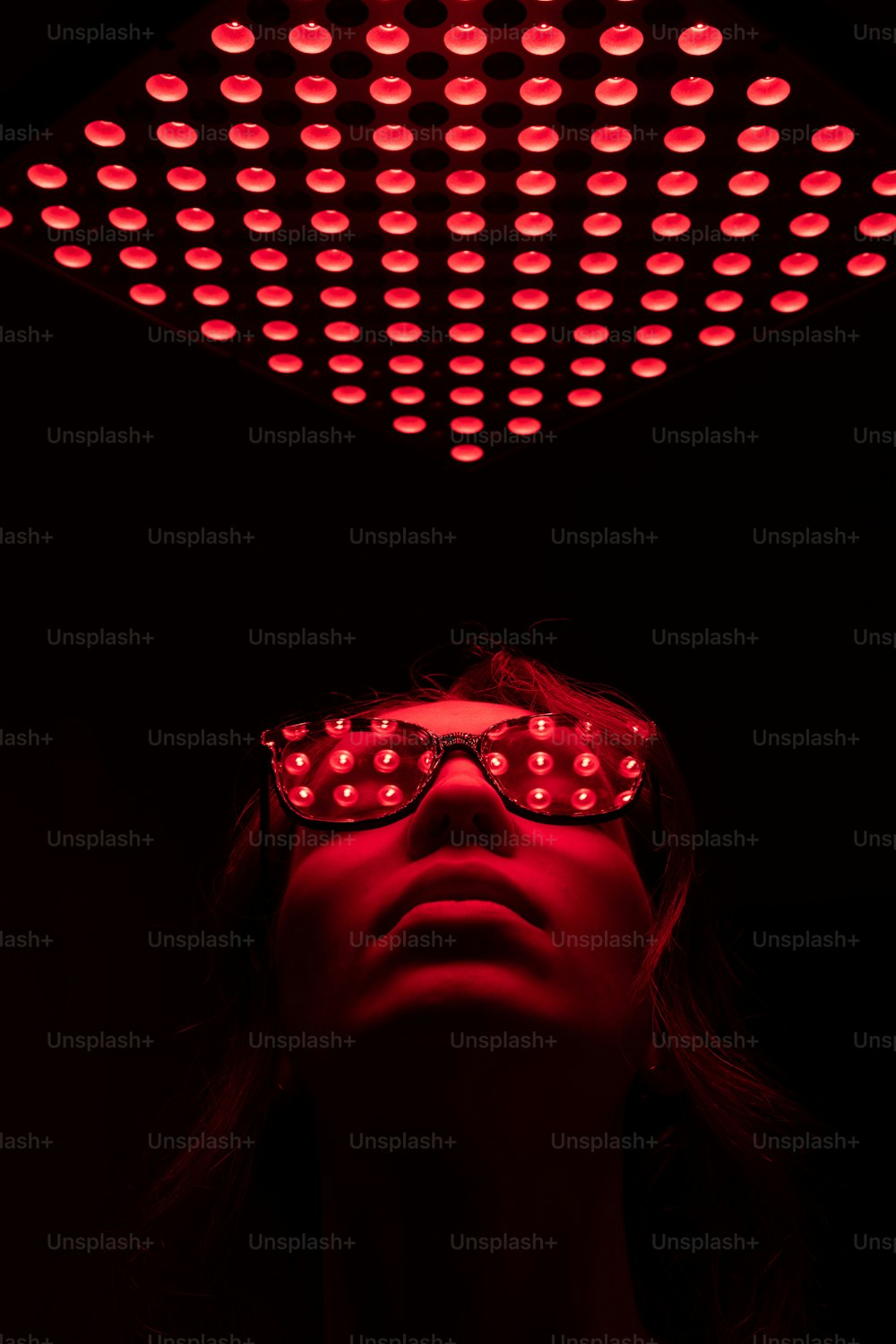 a woman wearing a pair of red light glasses