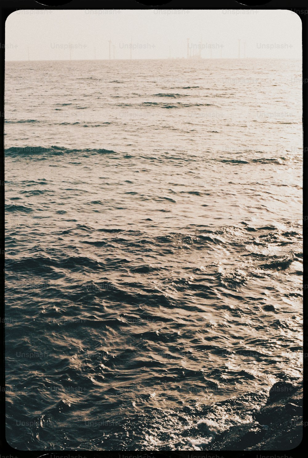 a large body of water sitting under a cloudy sky