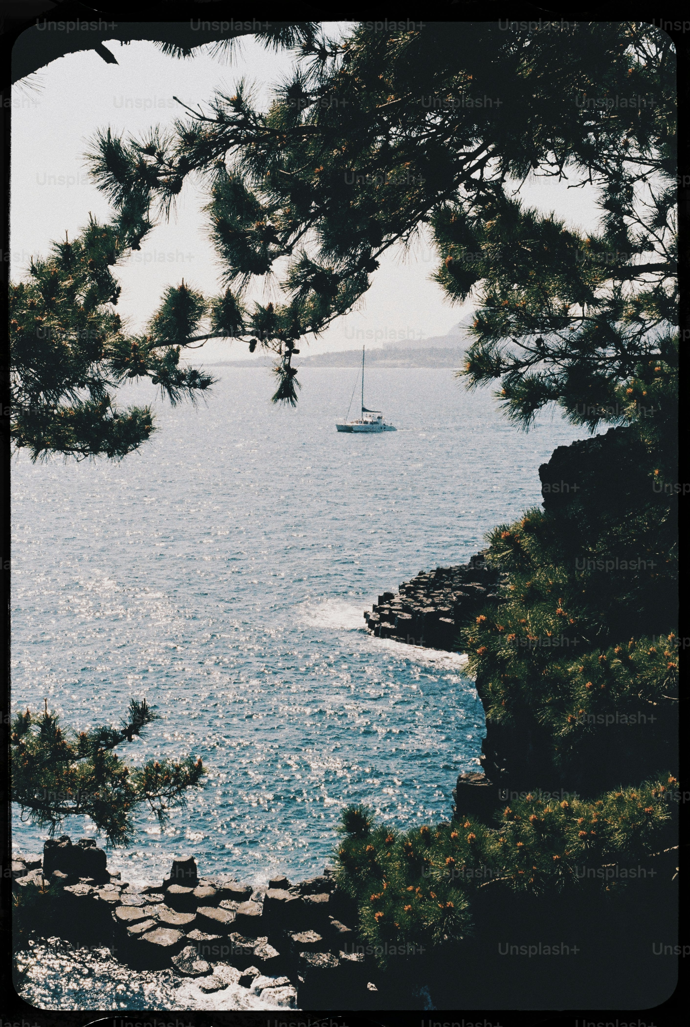 a boat is out on the water near the shore
