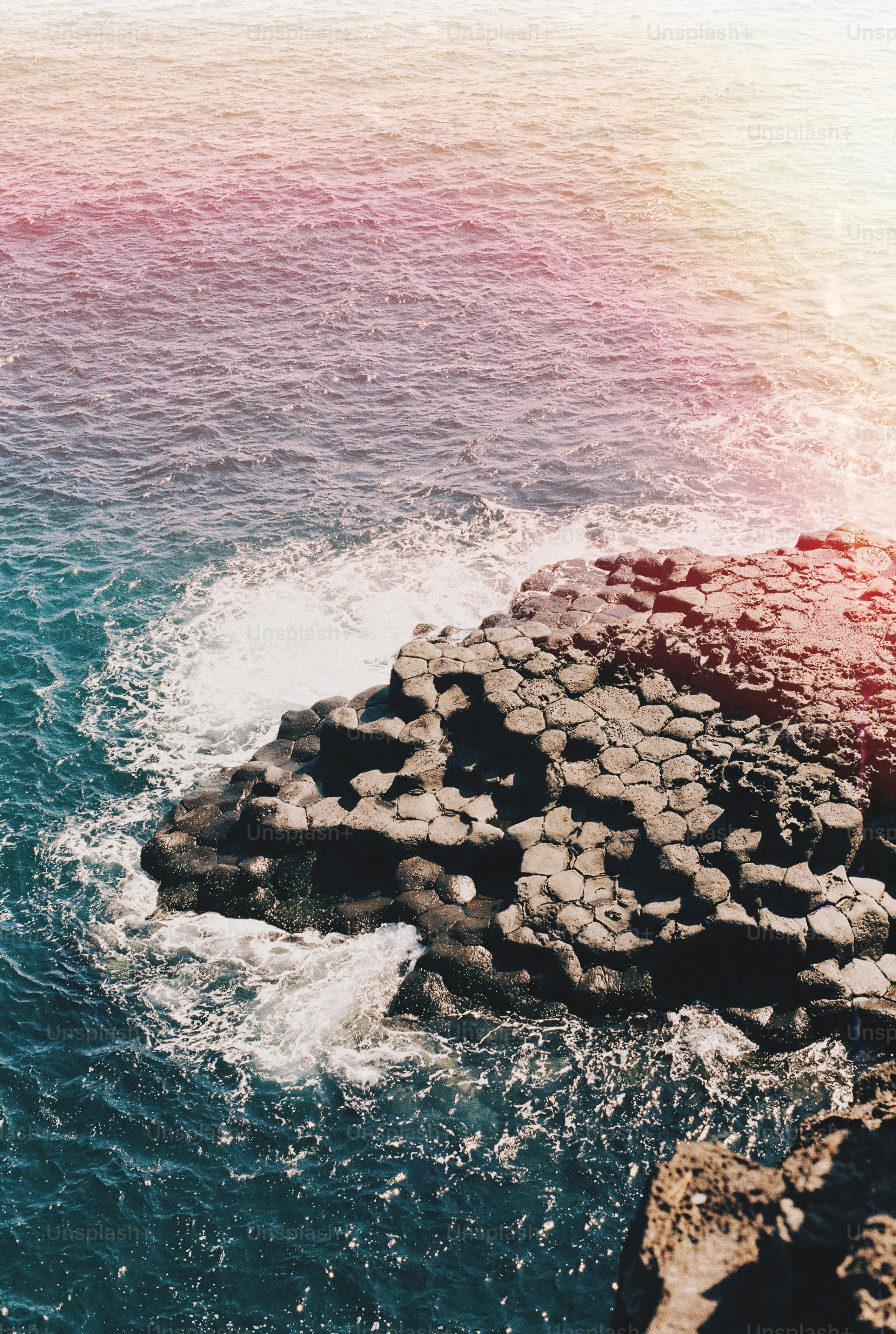 a rock formation in the middle of a body of water