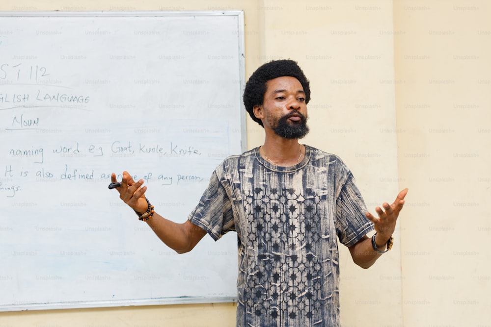 a man standing in front of a white board