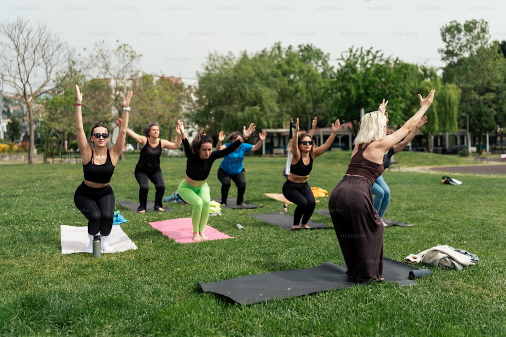 a group of women doing yoga in a park