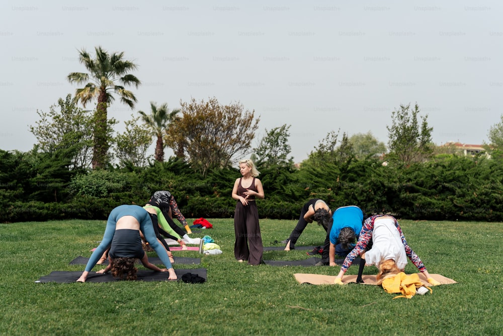 a group of people doing yoga in a park