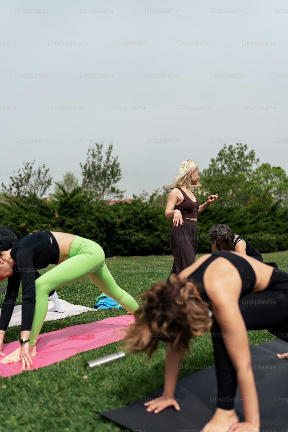 a group of people doing yoga in a park