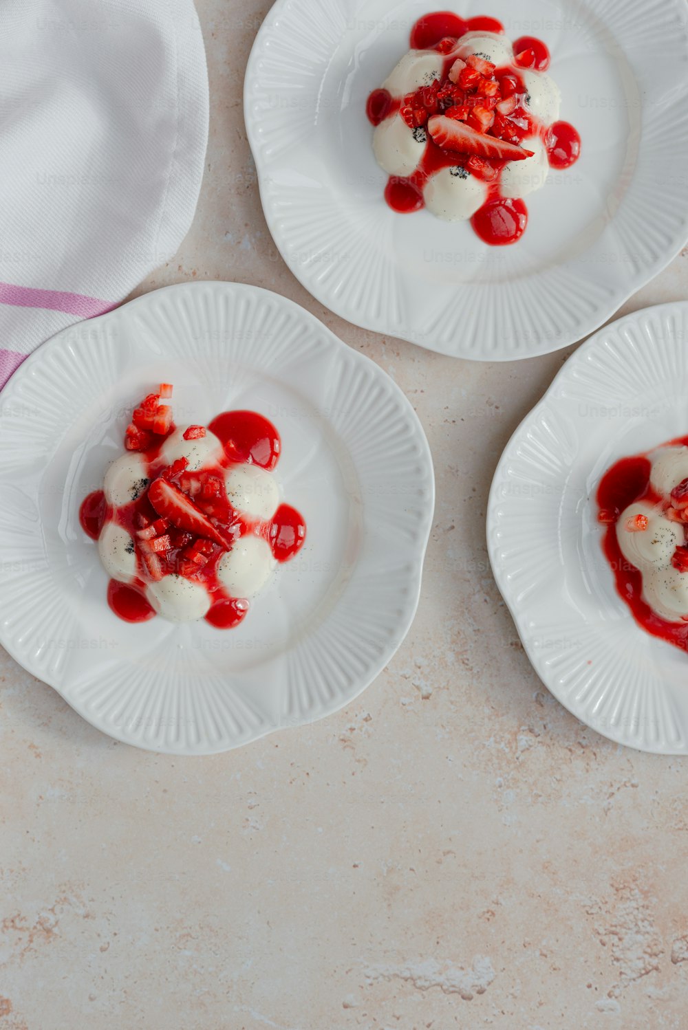 three white plates topped with food on top of a table