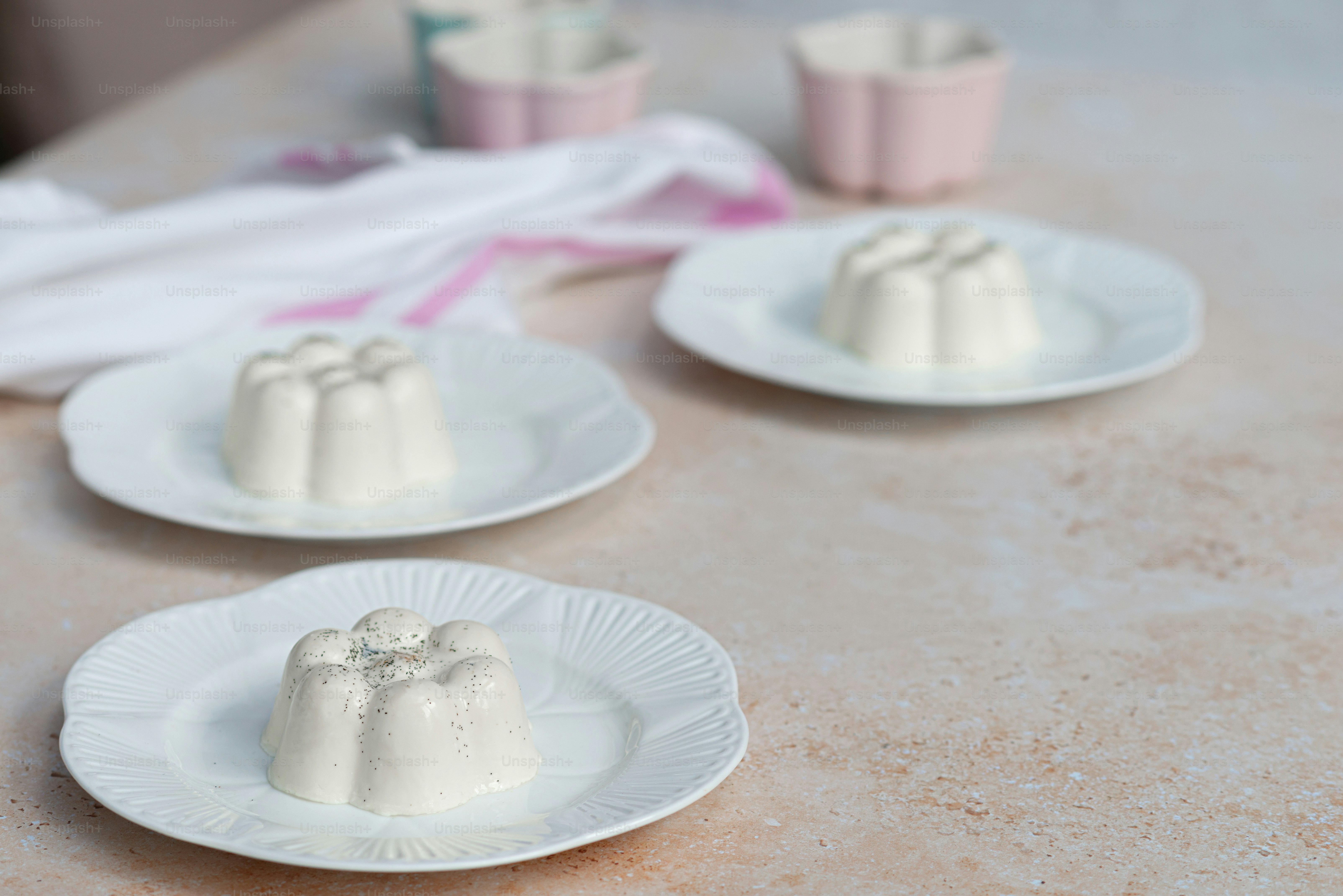 a table topped with three white plates filled with desserts
