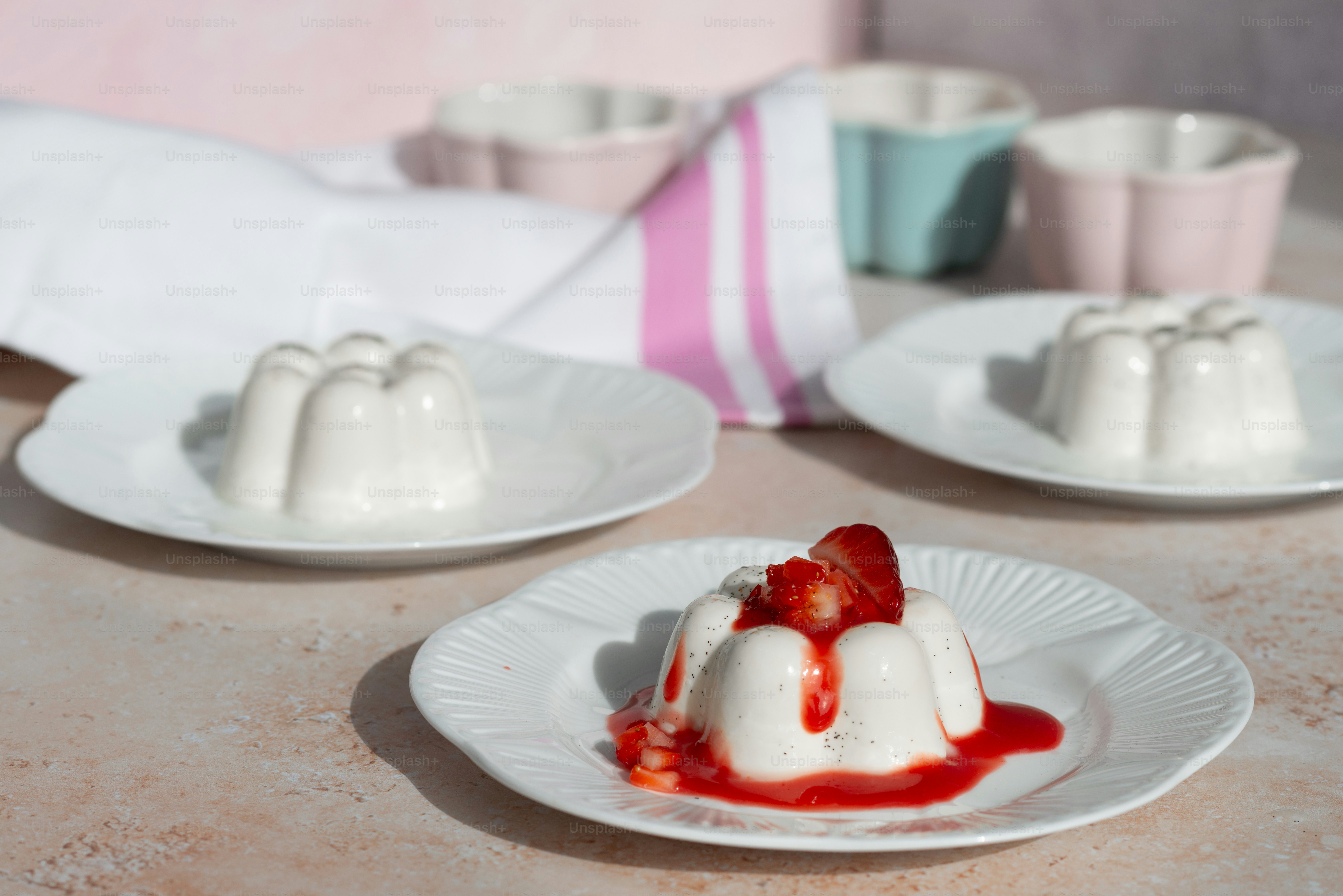 a table topped with white plates filled with dessert