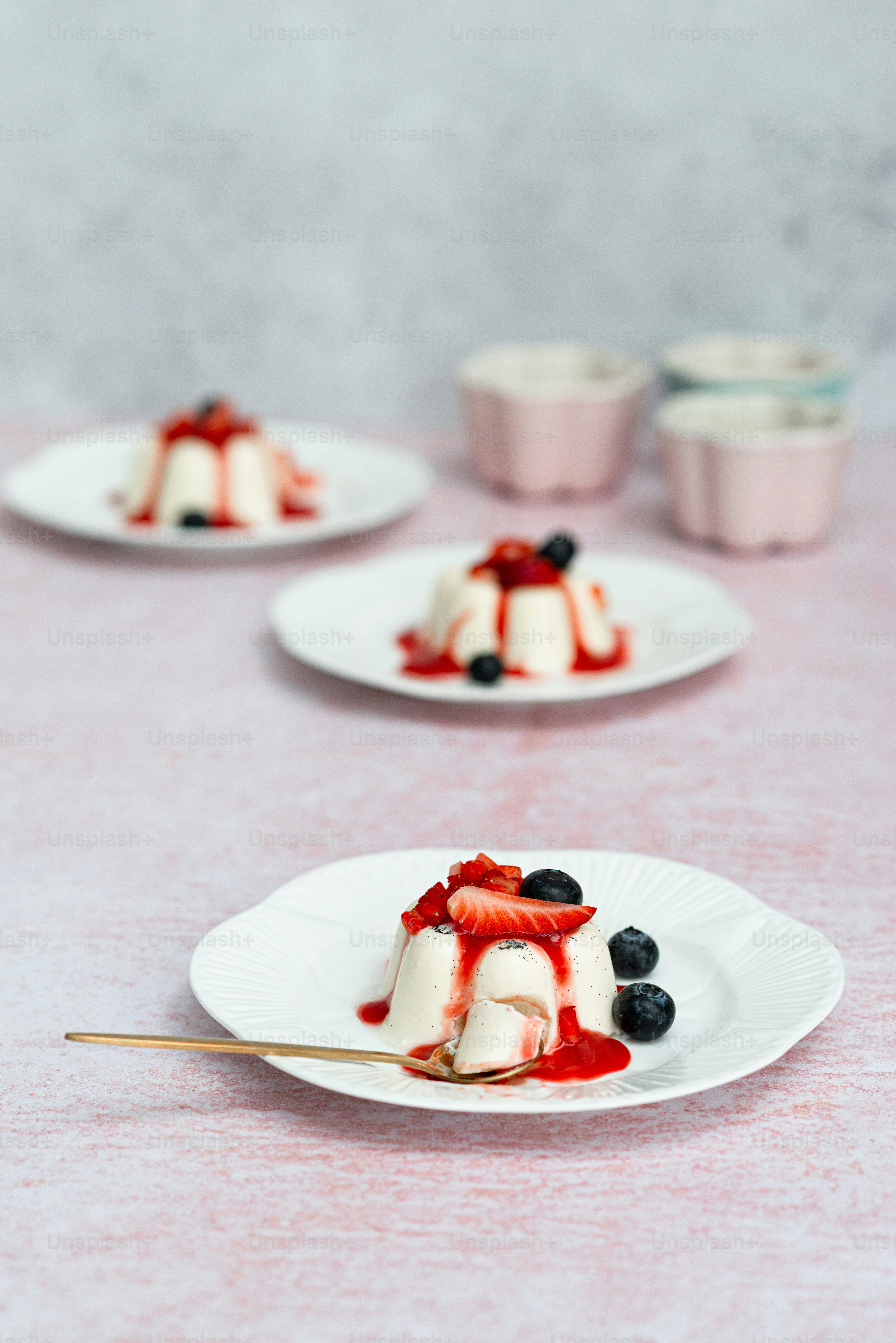 a table topped with plates of food covered in fruit