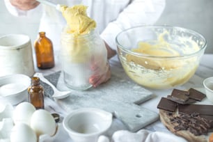 a person in a white coat is mixing some food