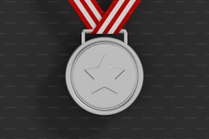 a silver medal with a red ribbon around it