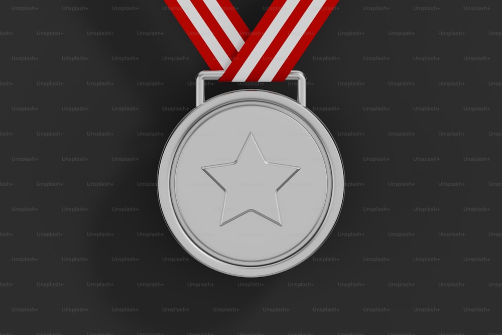 a silver medal with a red ribbon around it
