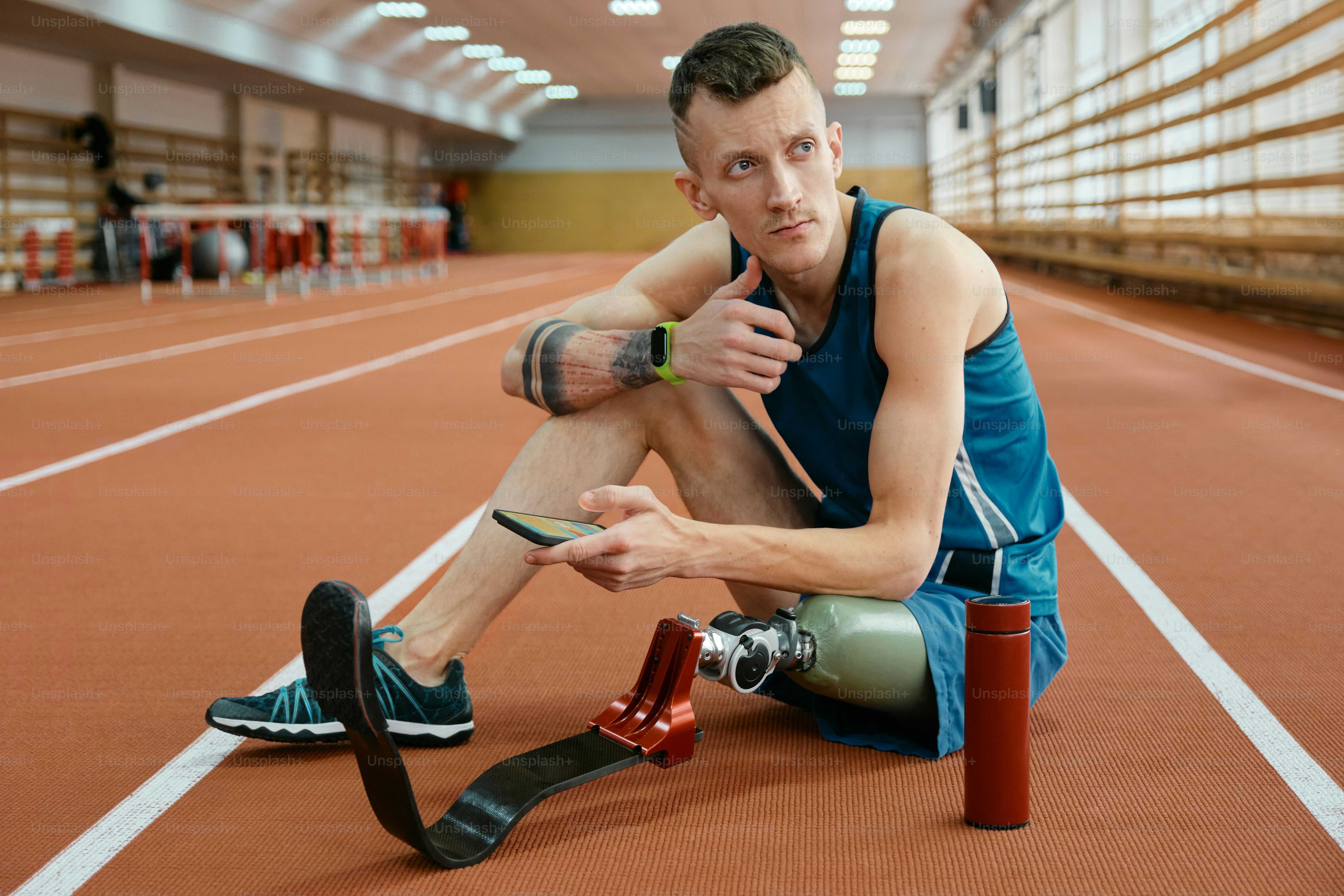 a man sitting on the ground with a camera