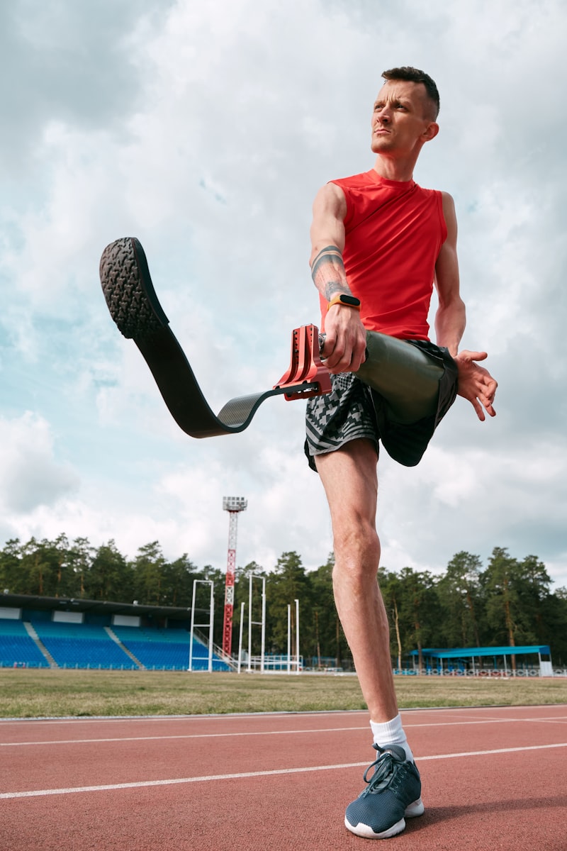 Amputee athlete warming up before a running workout with blade prosthetics