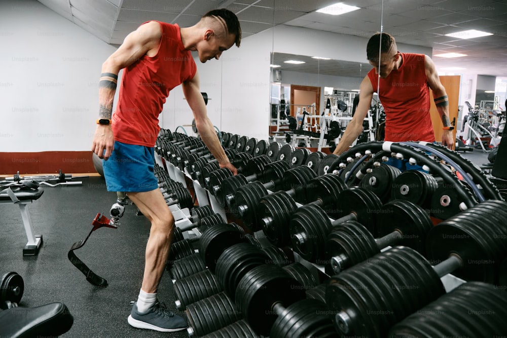 a couple of men standing next to each other in a gym