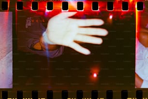 a hand reaching out of a film strip
