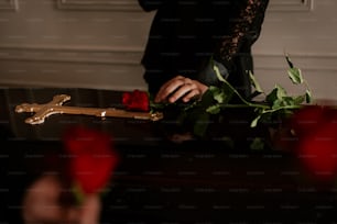 a person holding a cross and a rose
