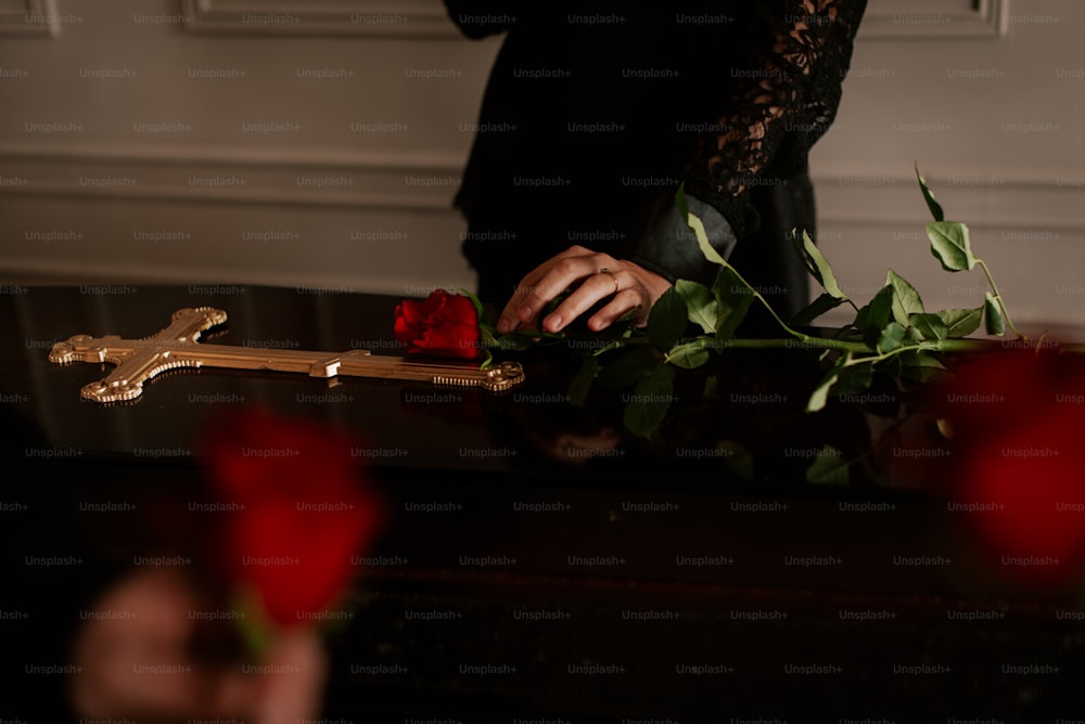 a person holding a cross and a rose