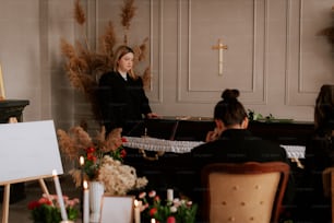 a woman standing next to a piano in a room