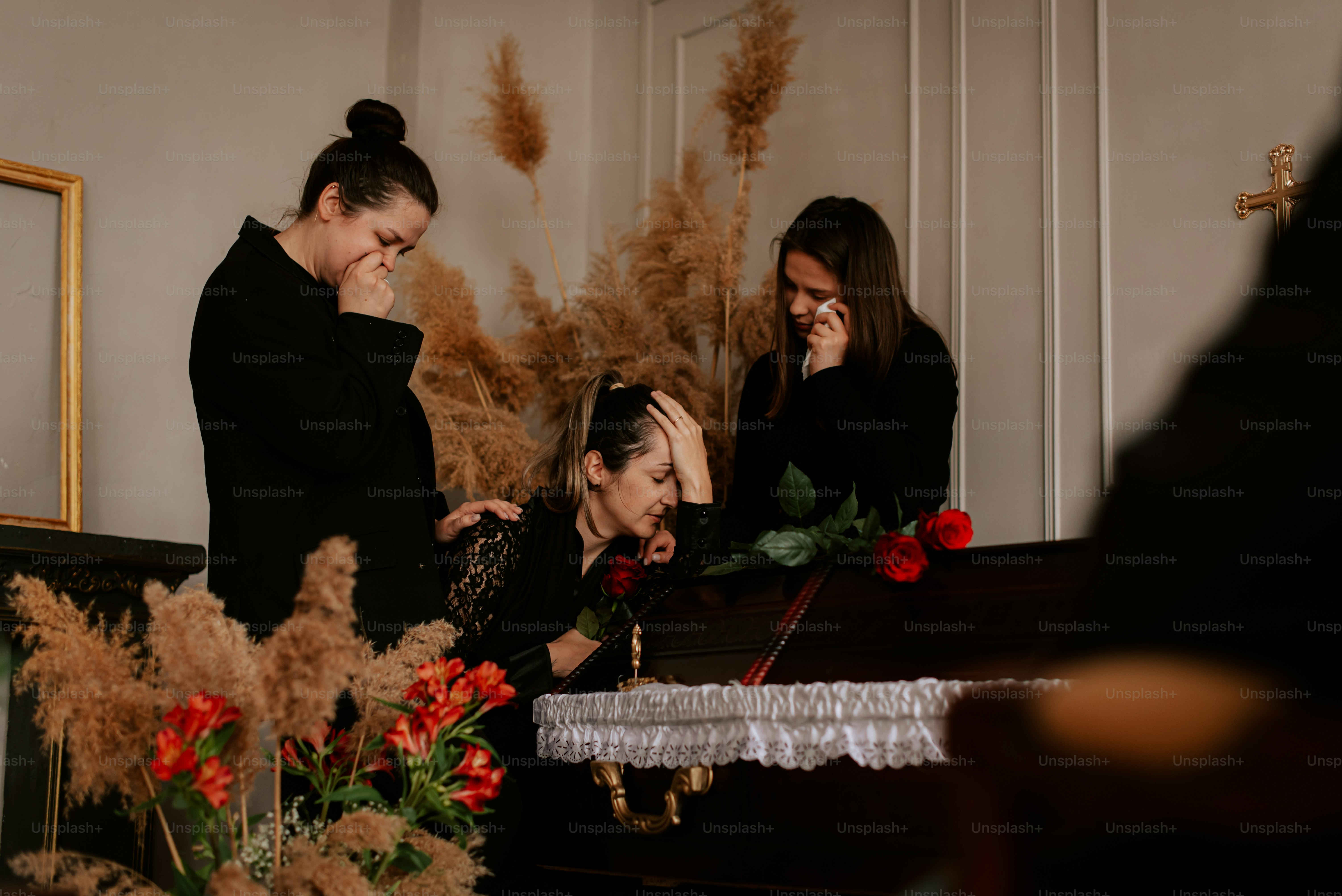 two women standing in front of a table with a cake on it