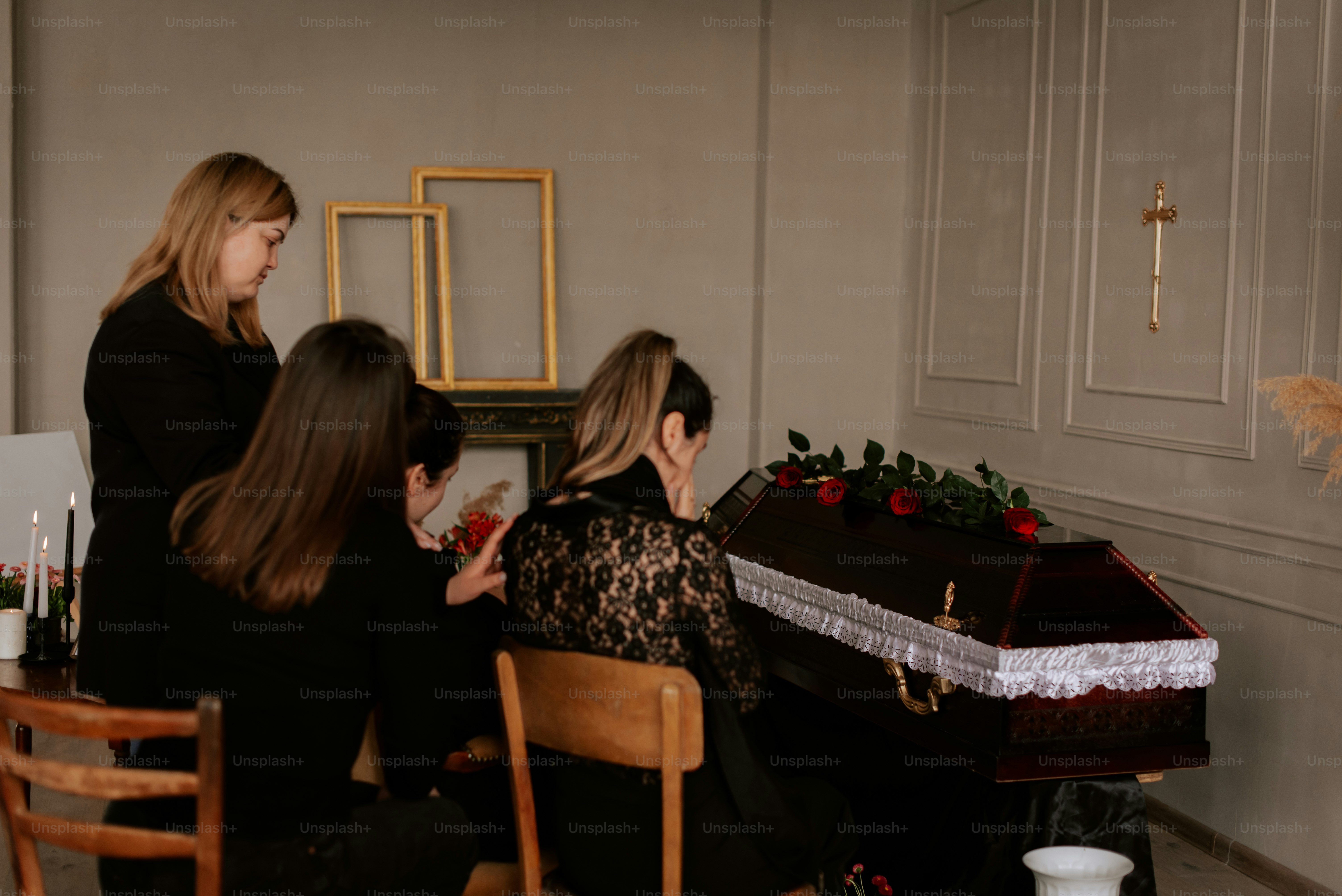 a group of women sitting around a table with a cake on it