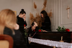 棺の周りに立つ女性たち