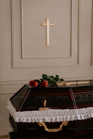 a wooden casket with a cross on top of it