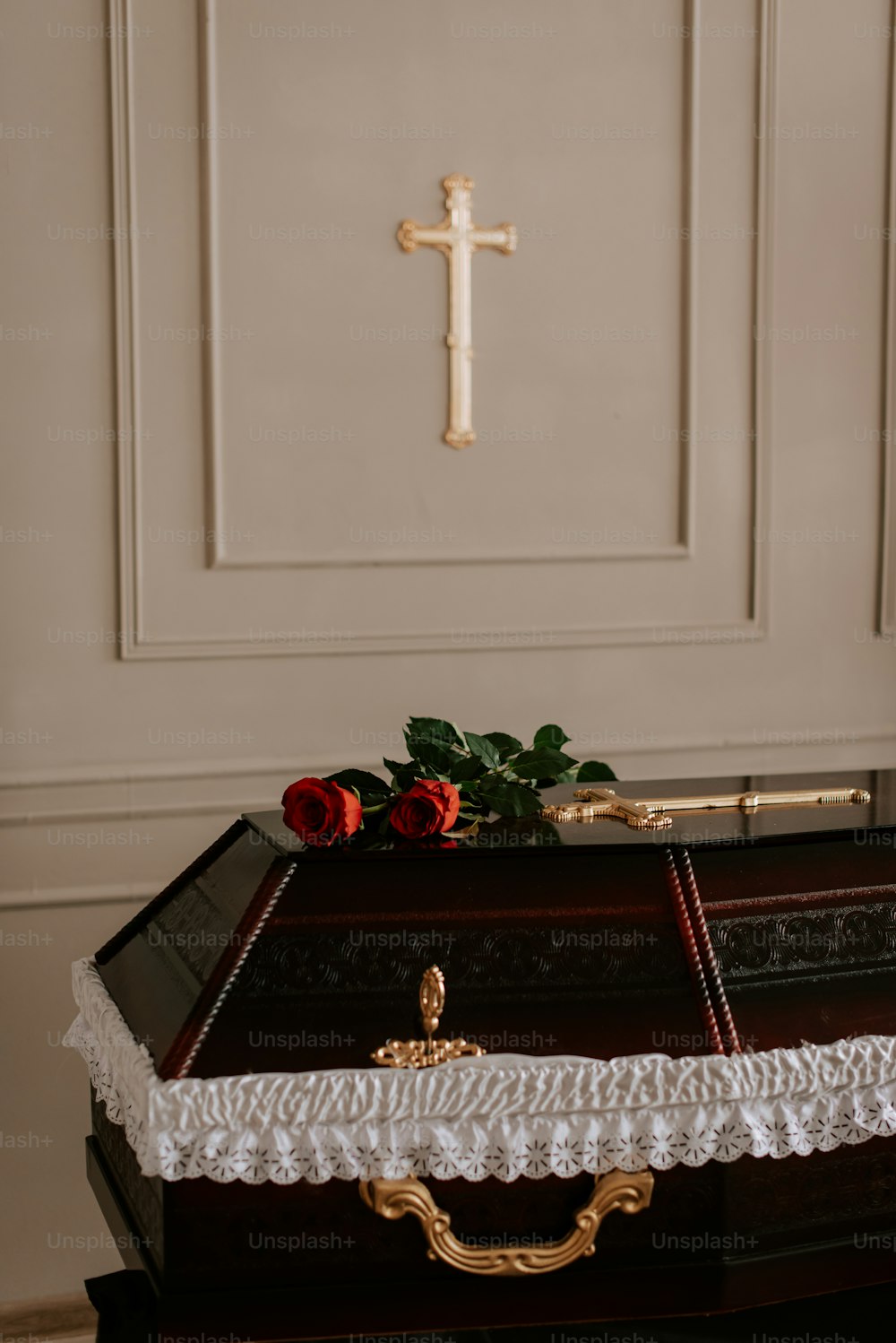 a wooden casket with a cross on top of it