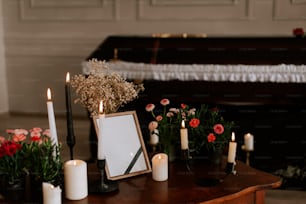 a wooden table topped with candles and flowers