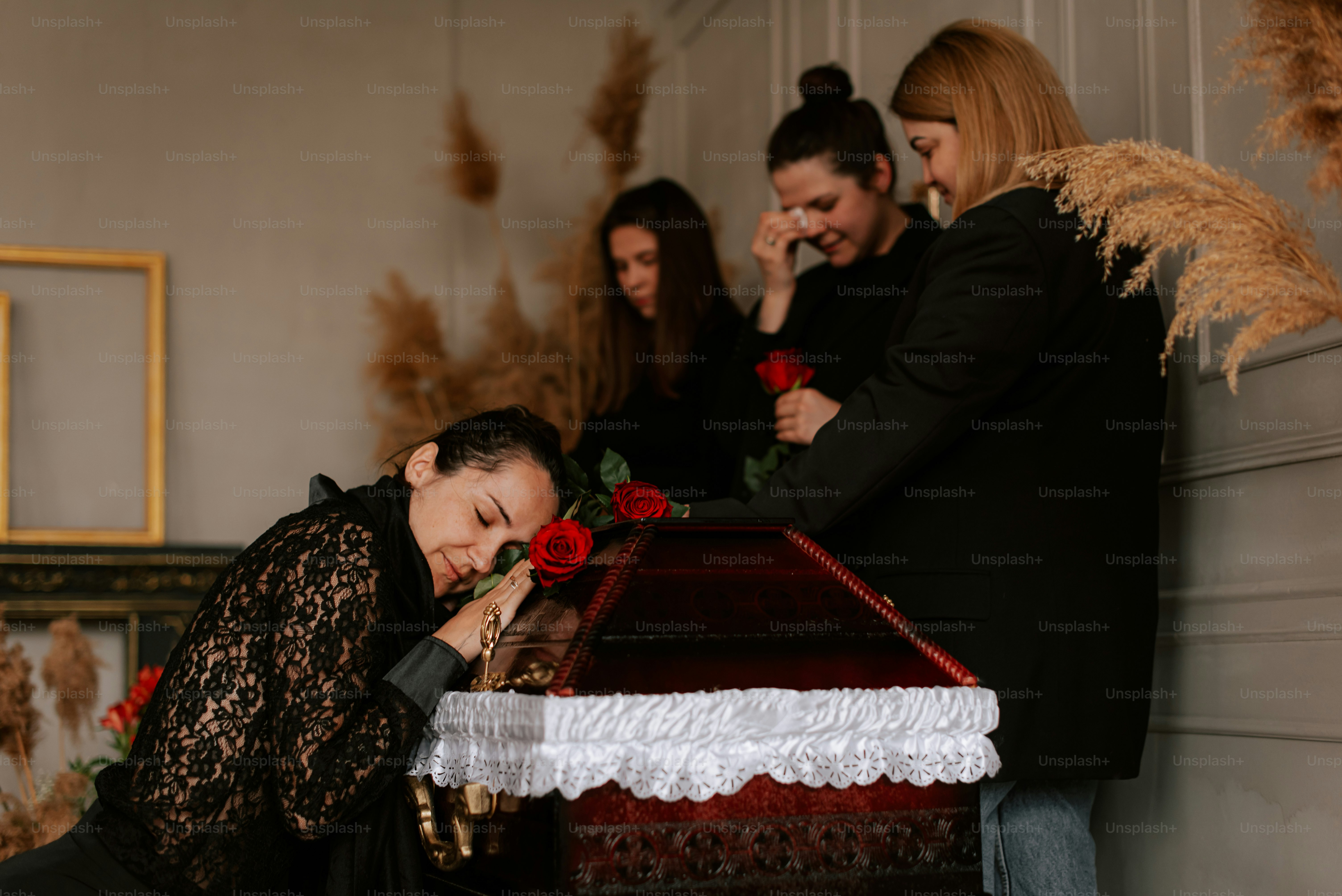 a group of women standing around a table with a cake on it