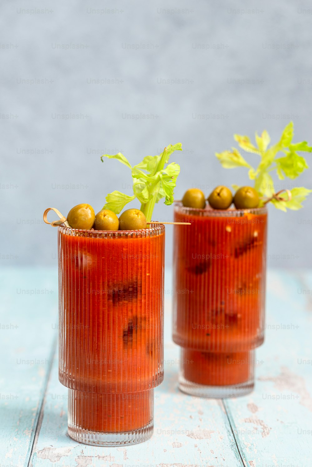 a couple of glasses filled with food on top of a table