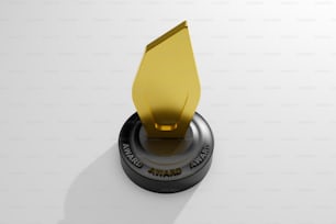 a golden award is placed on top of a black object