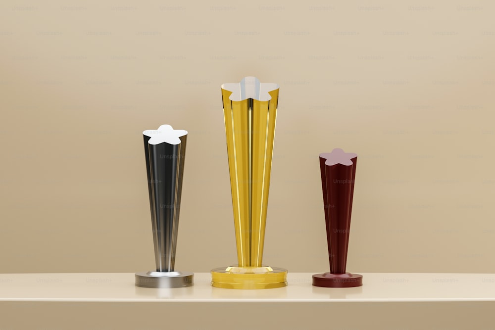 three different colored vases sitting on top of a table