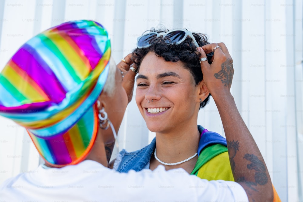 a man putting a hat on a woman's head