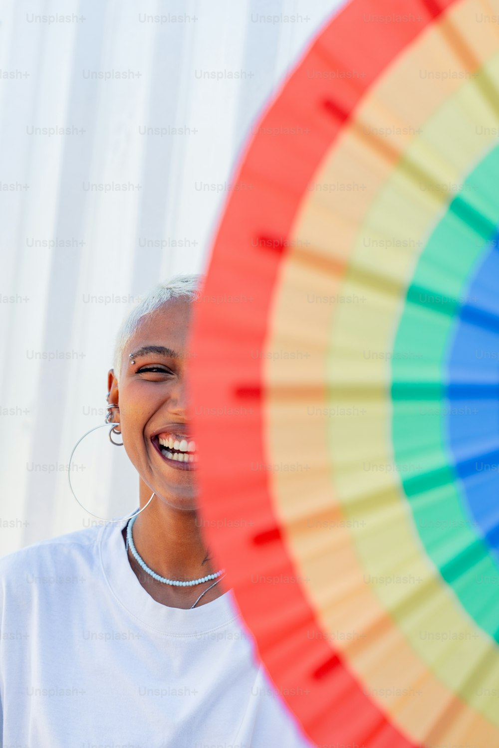 a woman smiling and holding a colorful frisbee
