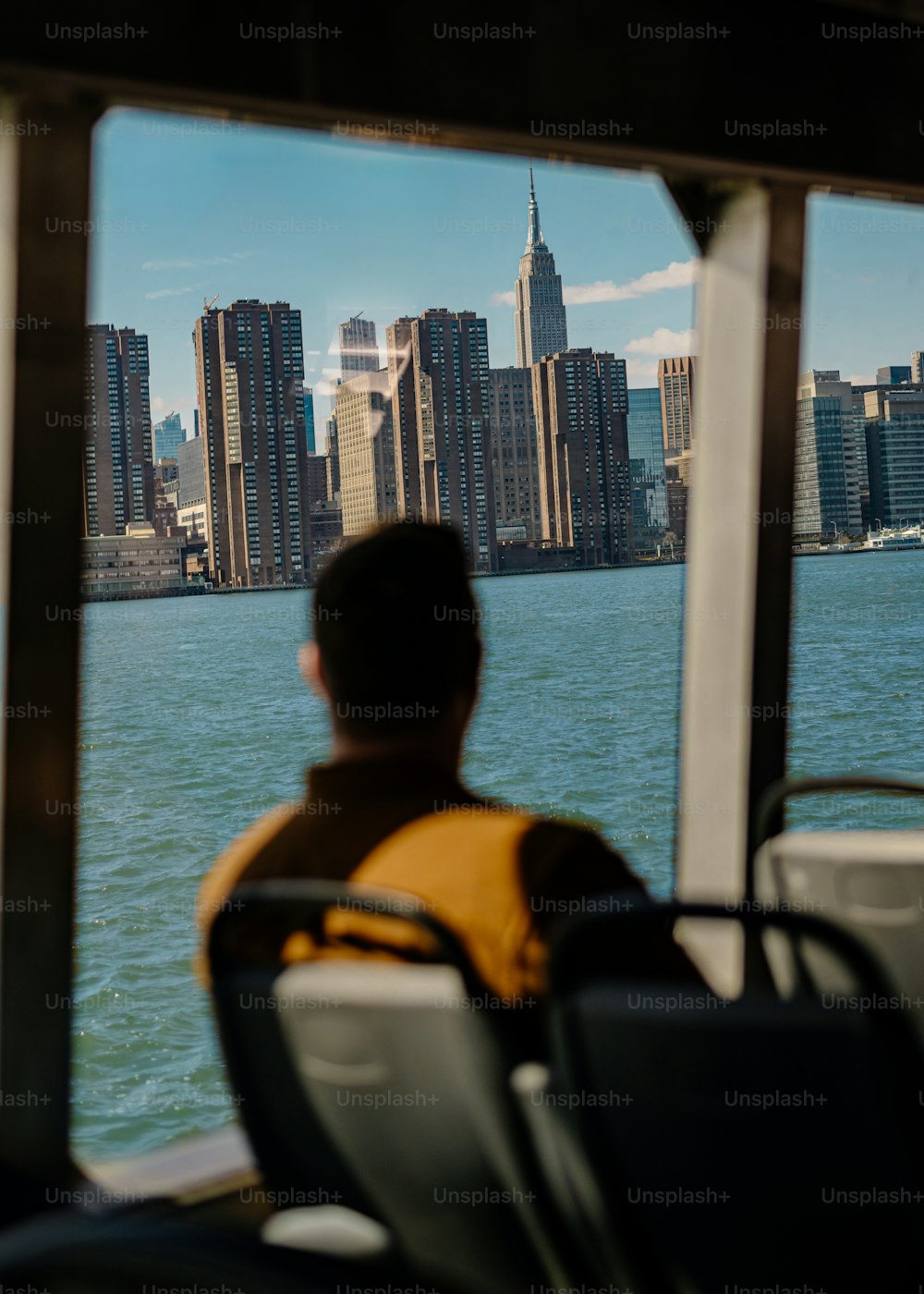 a man sitting on a bus looking out over the water