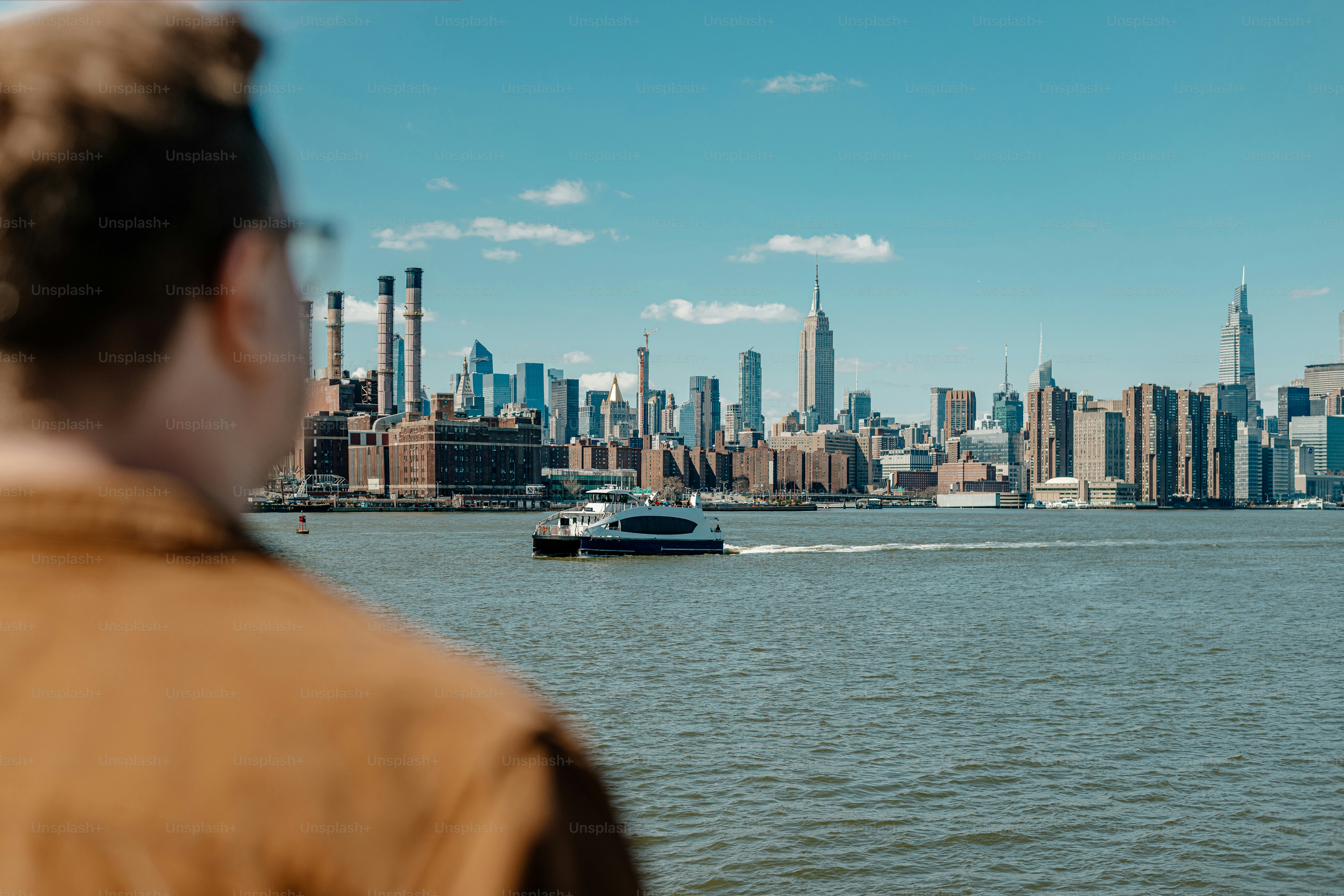 a man looking at a boat in the water