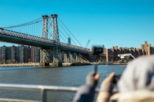 a person taking a picture of a bridge