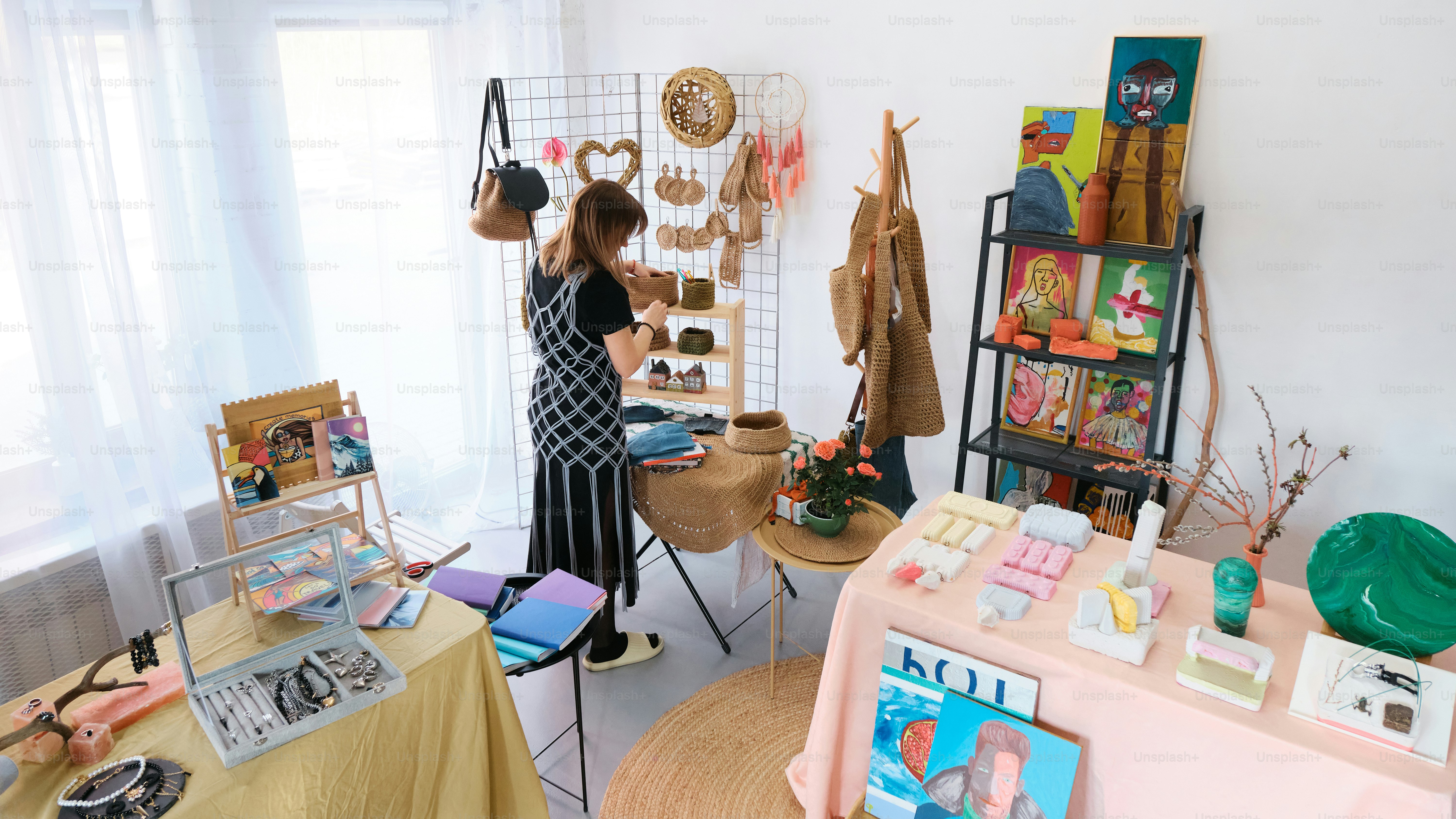 a woman standing in front of a display of hats