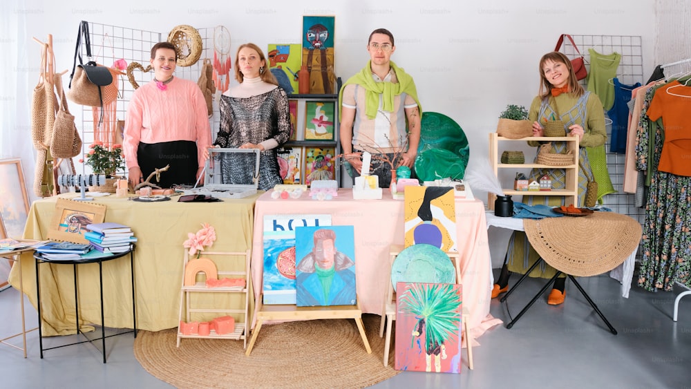 a group of people standing in front of a table