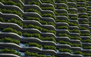 a very tall building with a bunch of plants growing on it