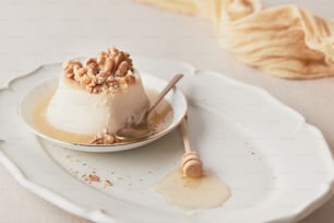 a panna cotta on a plate with a spoon