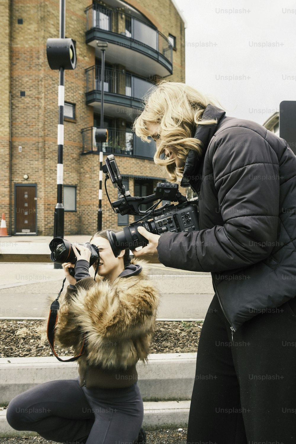 a woman taking a picture of another woman with a camera