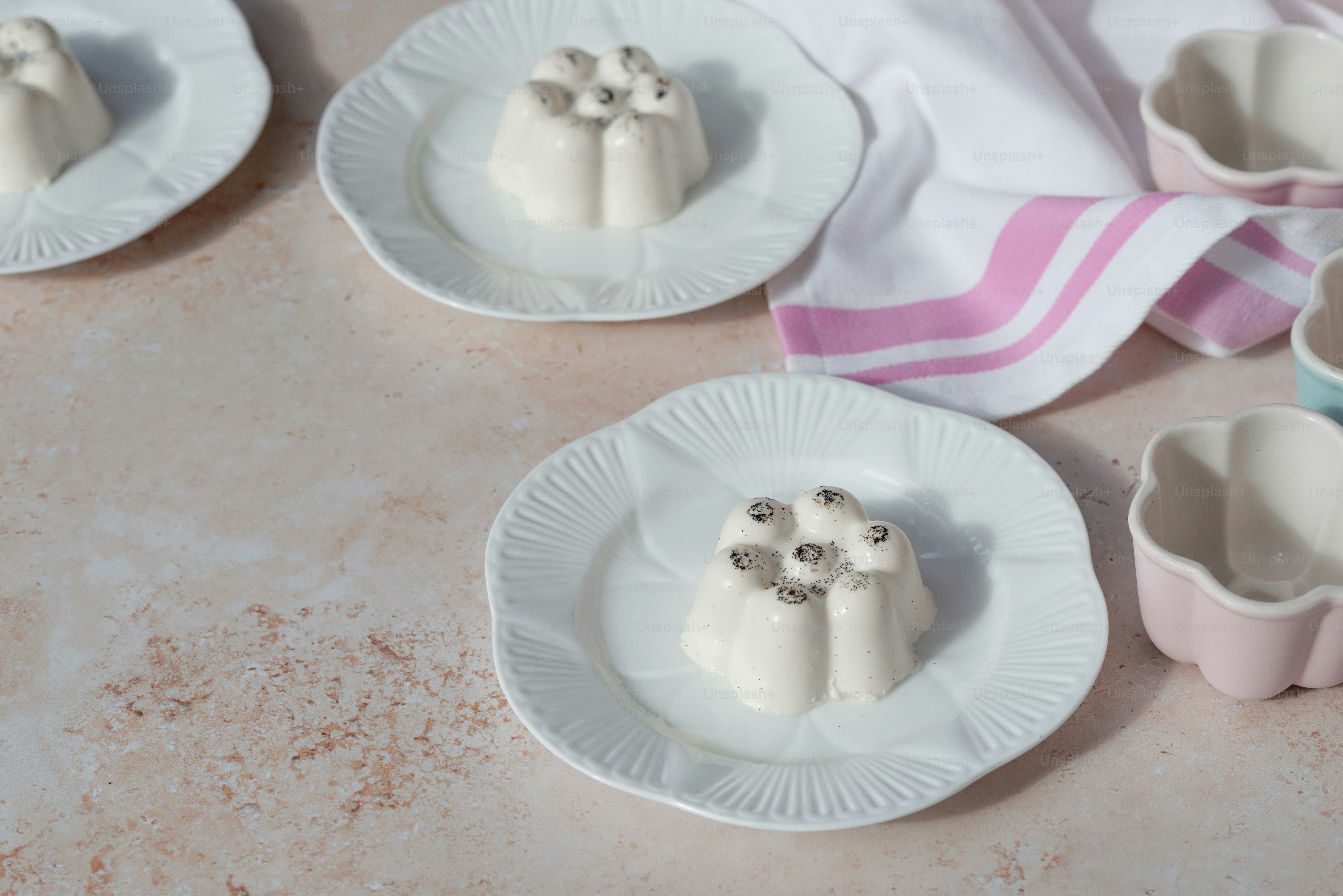 a table topped with white plates covered in food