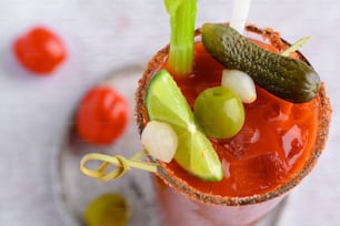 a bloody drink with a pickle on the rim