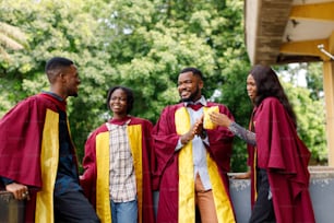 a group of people in graduation gowns standing next to each other