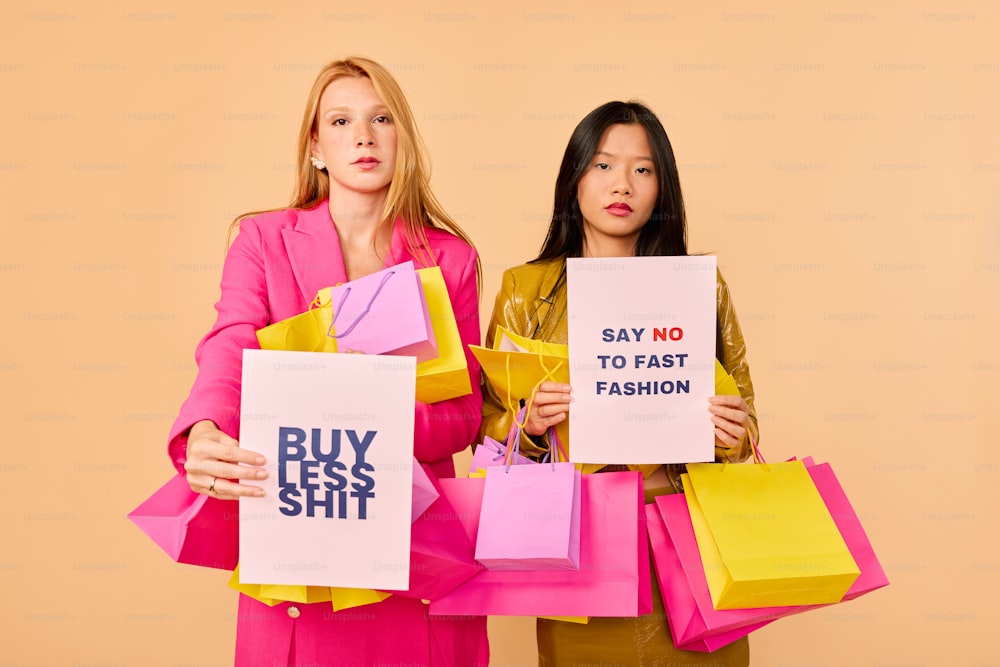 two women holding signs that say say no to fast fashion