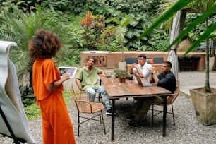 a group of people sitting around a wooden table