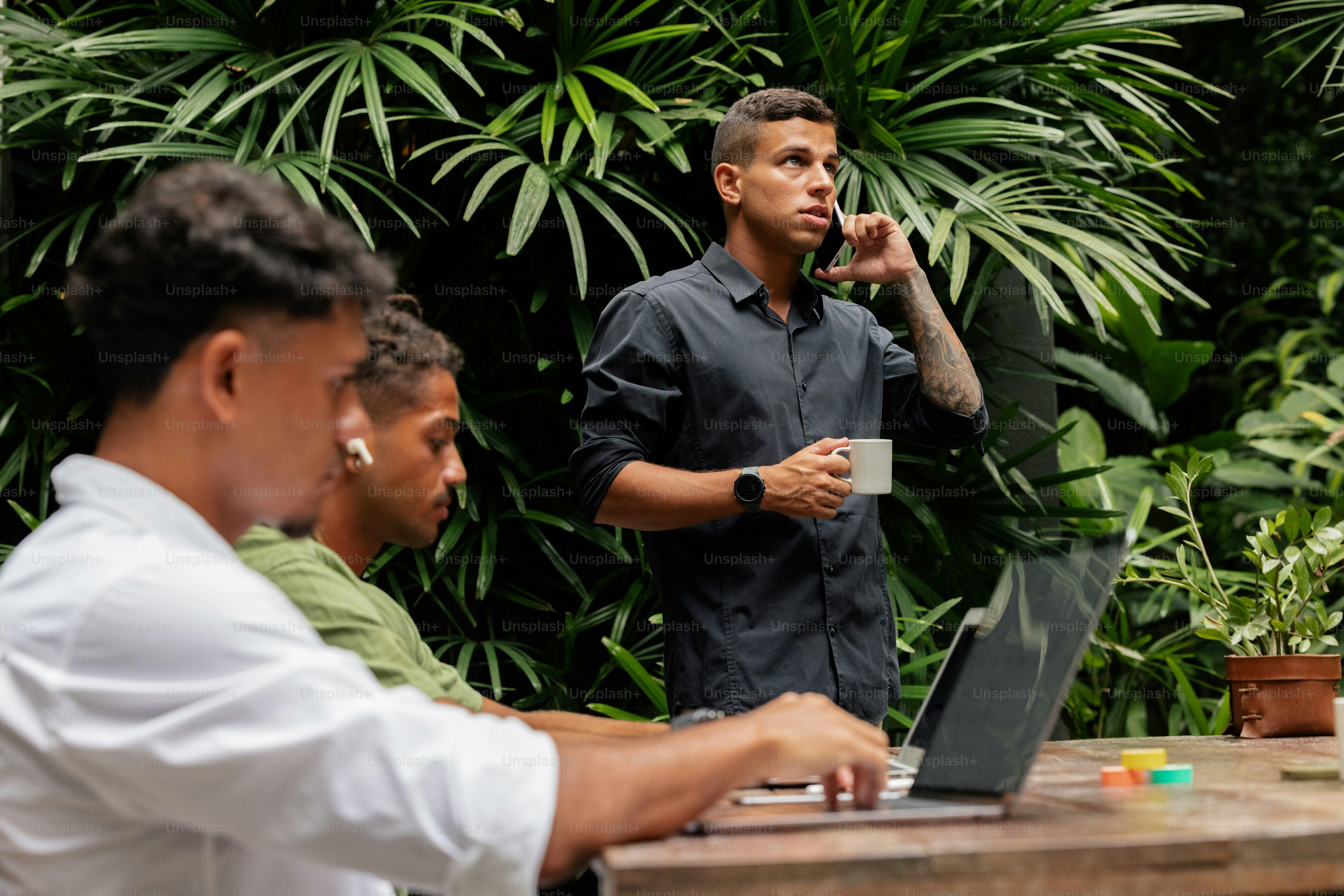 a man standing in front of a laptop computer