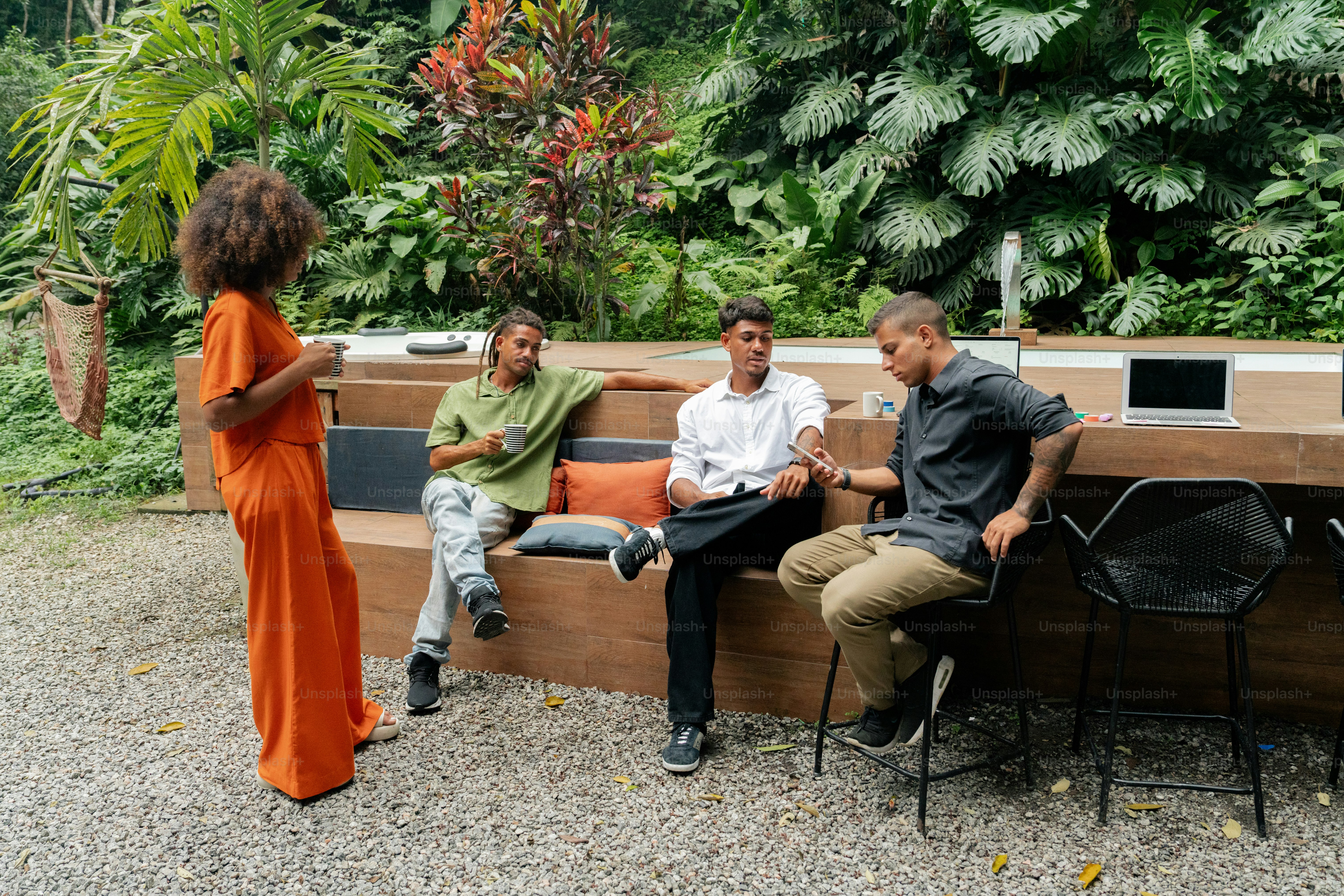 a group of people sitting on top of a wooden bench