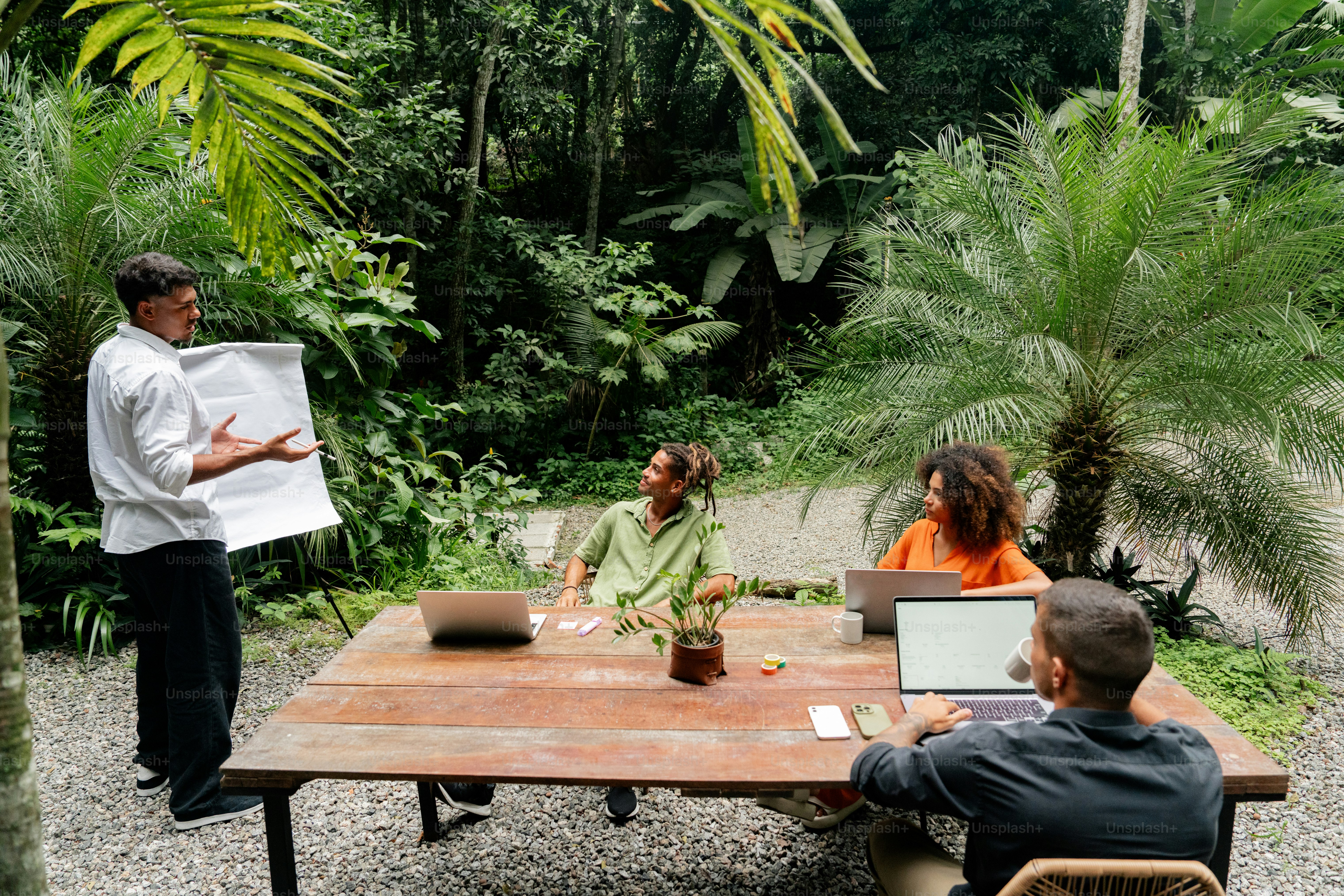 a group of people sitting around a wooden table